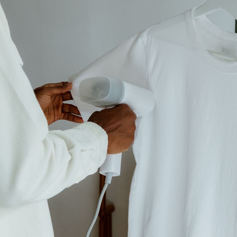 Sample photo: a presser steaming a white shirt