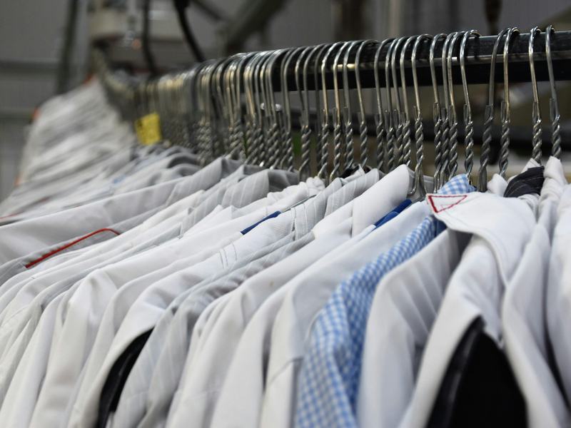 Sample photo: pressed shirts hanging on a dry cleaner's garment conveyor rail